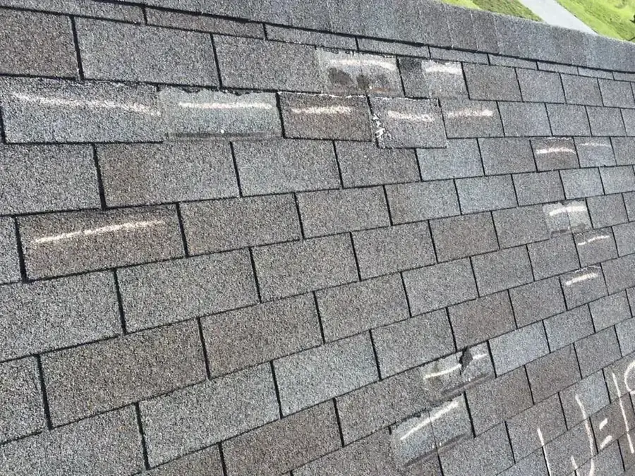 Roofer inspecting shingles after installation — Concord area roof replacement by Southern Star Roofing